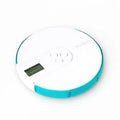 7 compartment white and blue alarm clock pill dispenser with a circular pill box and digital dosage time display
