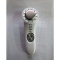 White 7 in 1 led facial machine and skin care massager with metallic circular head featuring cleansing and soothing modes