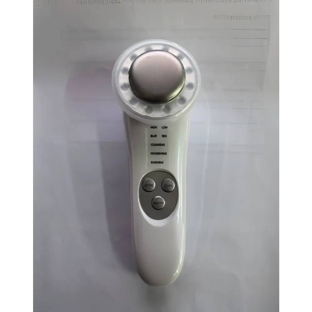 White 7 in 1 led facial machine and skin care massager with metallic circular head featuring cleansing and soothing modes