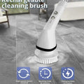 White wireless electric cleaning brush with ergonomic handle, soft bristles, and multiple attachments for versatile use