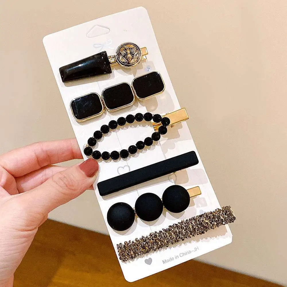 Set of seven black and gold delicate hair clips with matte, beaded, and sparkling designs for summer sweet girl style