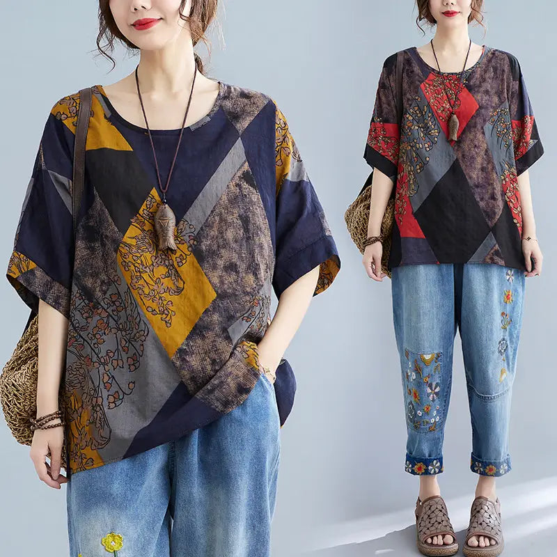 Stylish loose round neck printed patchwork blouse with an oversized fit featuring geometric panels in navy blue, mustard yellow, gray, and red adorned with floral embroidery.