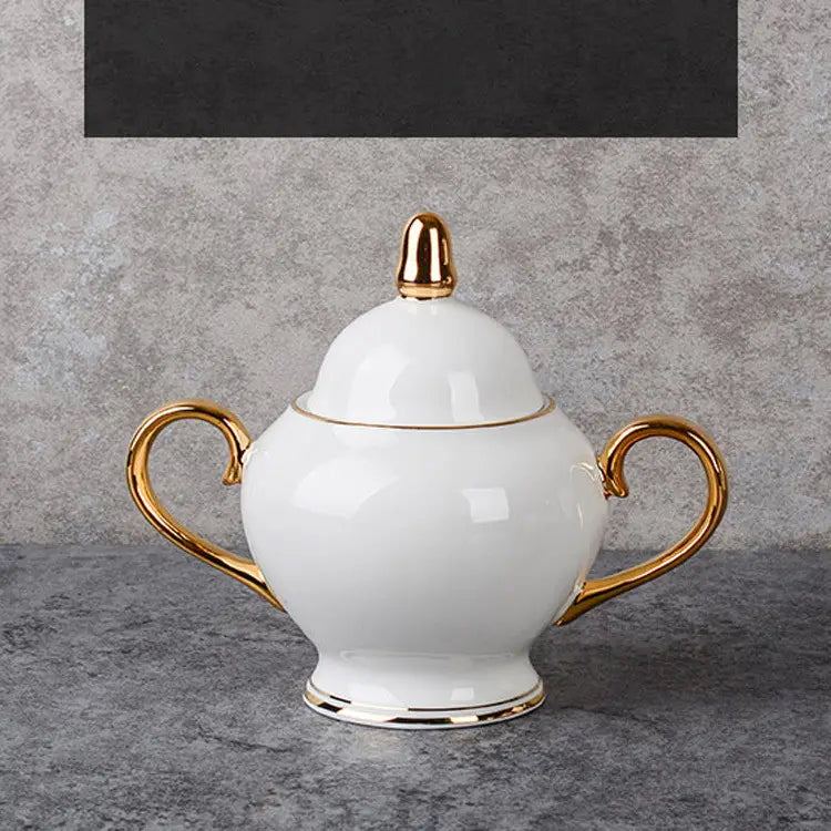 white ceramic sugar bowl with gold accents on the lid handles and base from a bone china coffee cup and saucer afternoon tea set