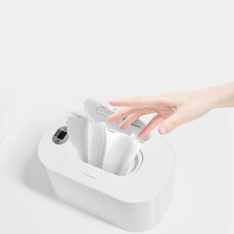 white plastic household baby wet wipes heater and dispenser with digital display and lid being opened by hand, designed for convenient wet wipes quantity management.
