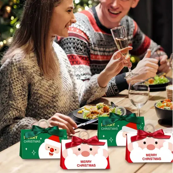 10 santa claus christmas candy boxes featuring christmas candy bags with santa claus faces in green and red colors and satin ribbon ties.
