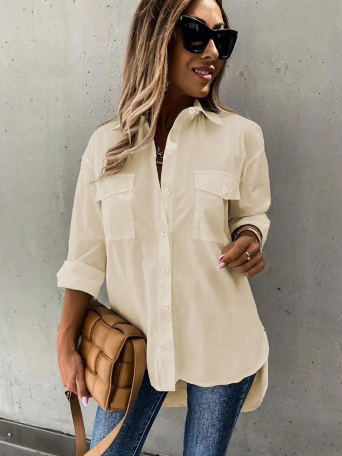 cream-colored lightweight cotton long sleeve lapel button down shirt with two chest pockets and rolled sleeves