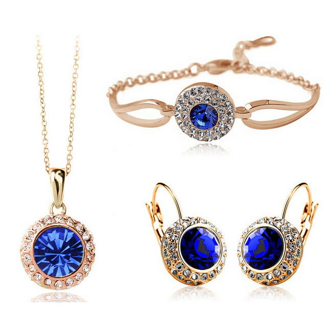 korean style jewelry set featuring rose gold-toned silver with a central deep blue crystal surrounded by smaller clear crystals in each piece