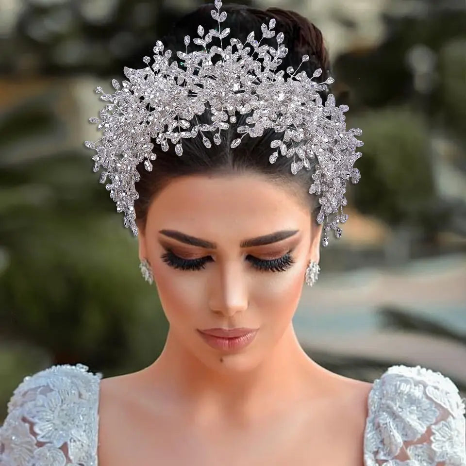 A sparkling silver crystal heavy handmade rhinestone tiara with intricate leaf and branch designs ideal for snow queen wedding use.