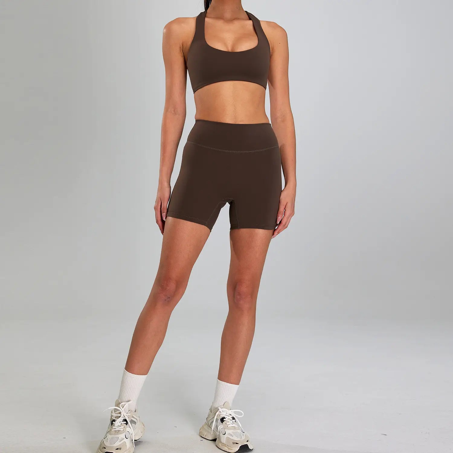 brown seamless athletic two-piece sports suit outdoor featuring a crop top and high-waisted shorts ideal for outdoor running nude activities