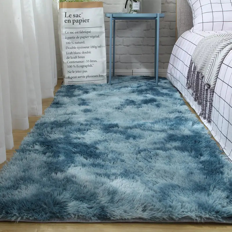 A plush gray shaggy carpet floor mat featuring a soft and fluffy gradient blue texture ideal for a plush carpet floor.