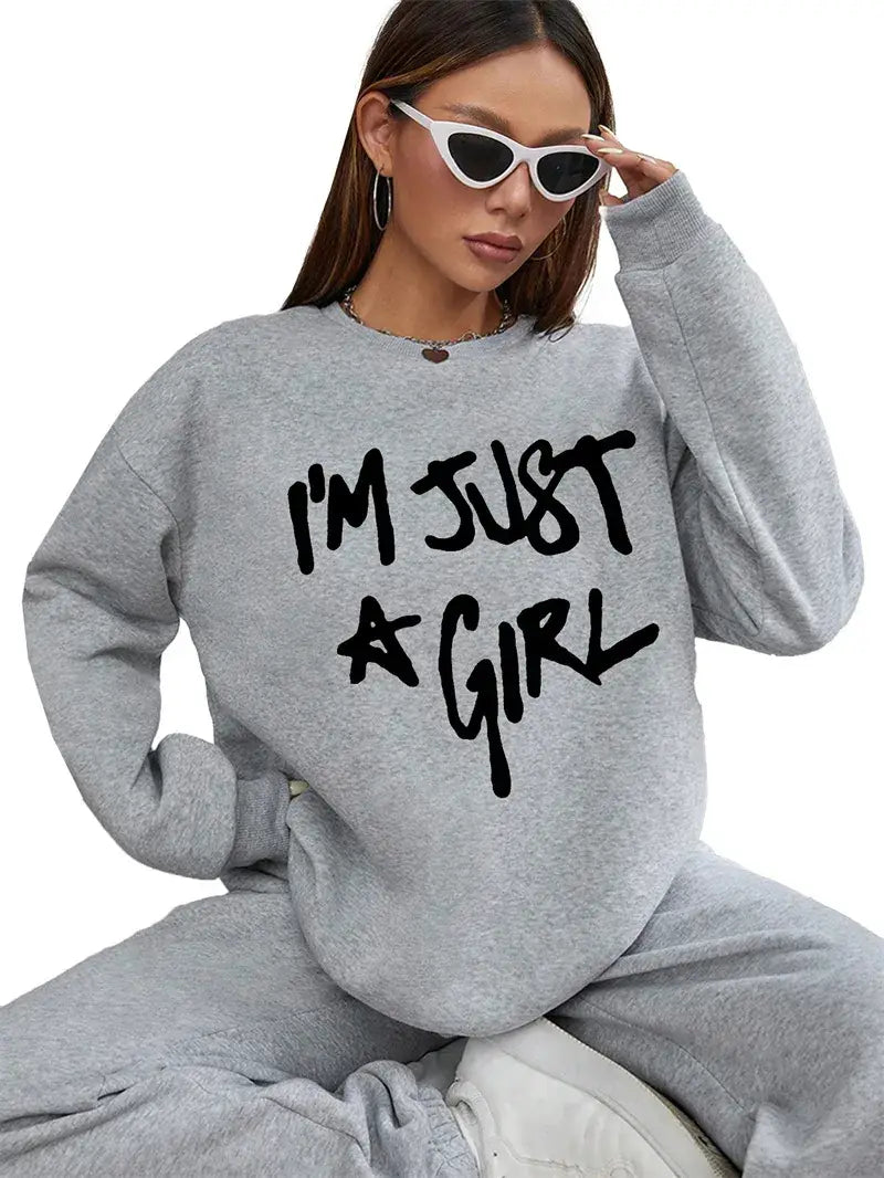 gray oversized sweatshirt with black girl print round neck text im just a girl across the chest in soft cotton material