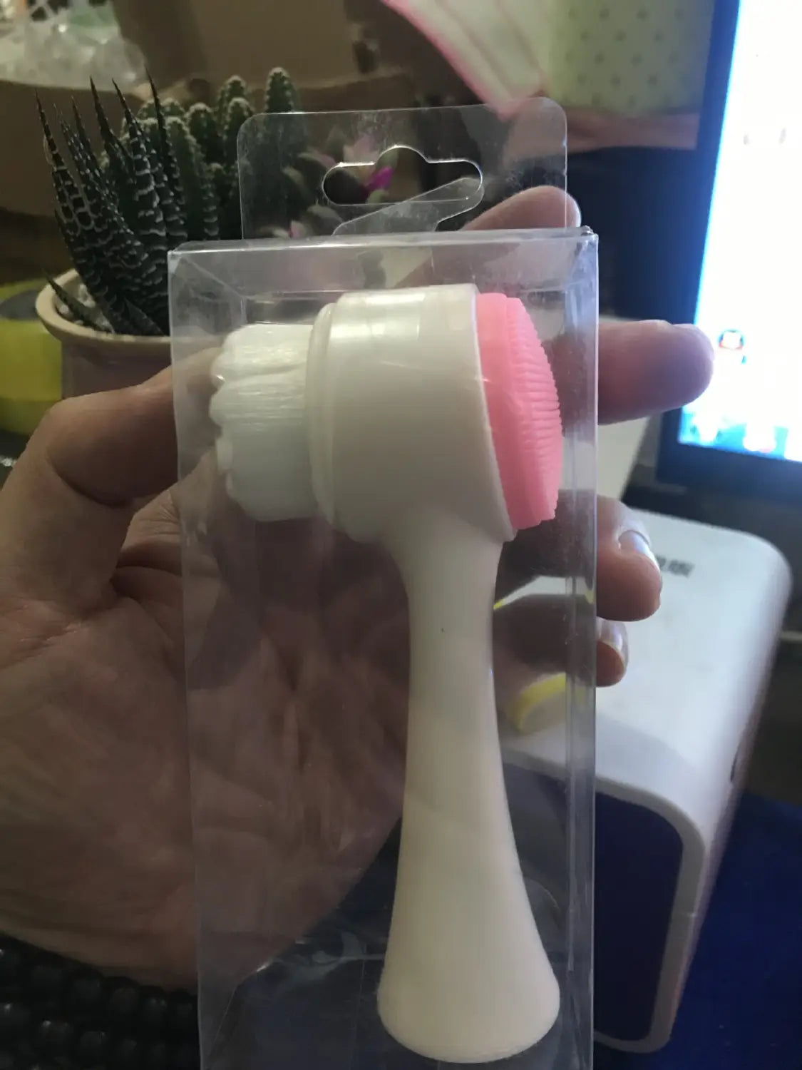 Dual sided silicone beauty skin care face wash in pink and white is a silicone cleansing instrument packaged in clear plastic for effective skin care face use.