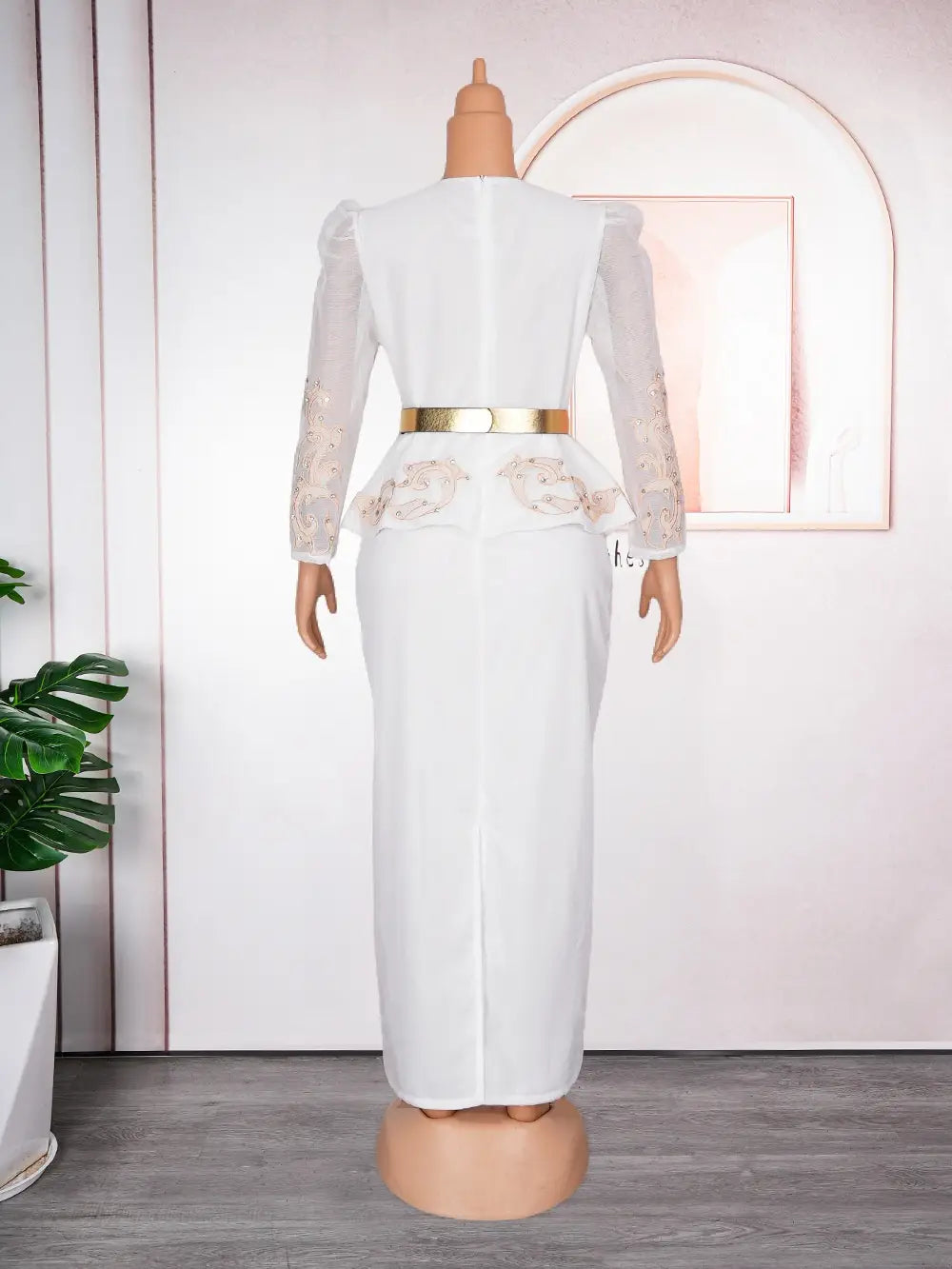 white peplum dress with sheer long sleeves and gold belt styled as a luxury rhinestone beaded formal dress.