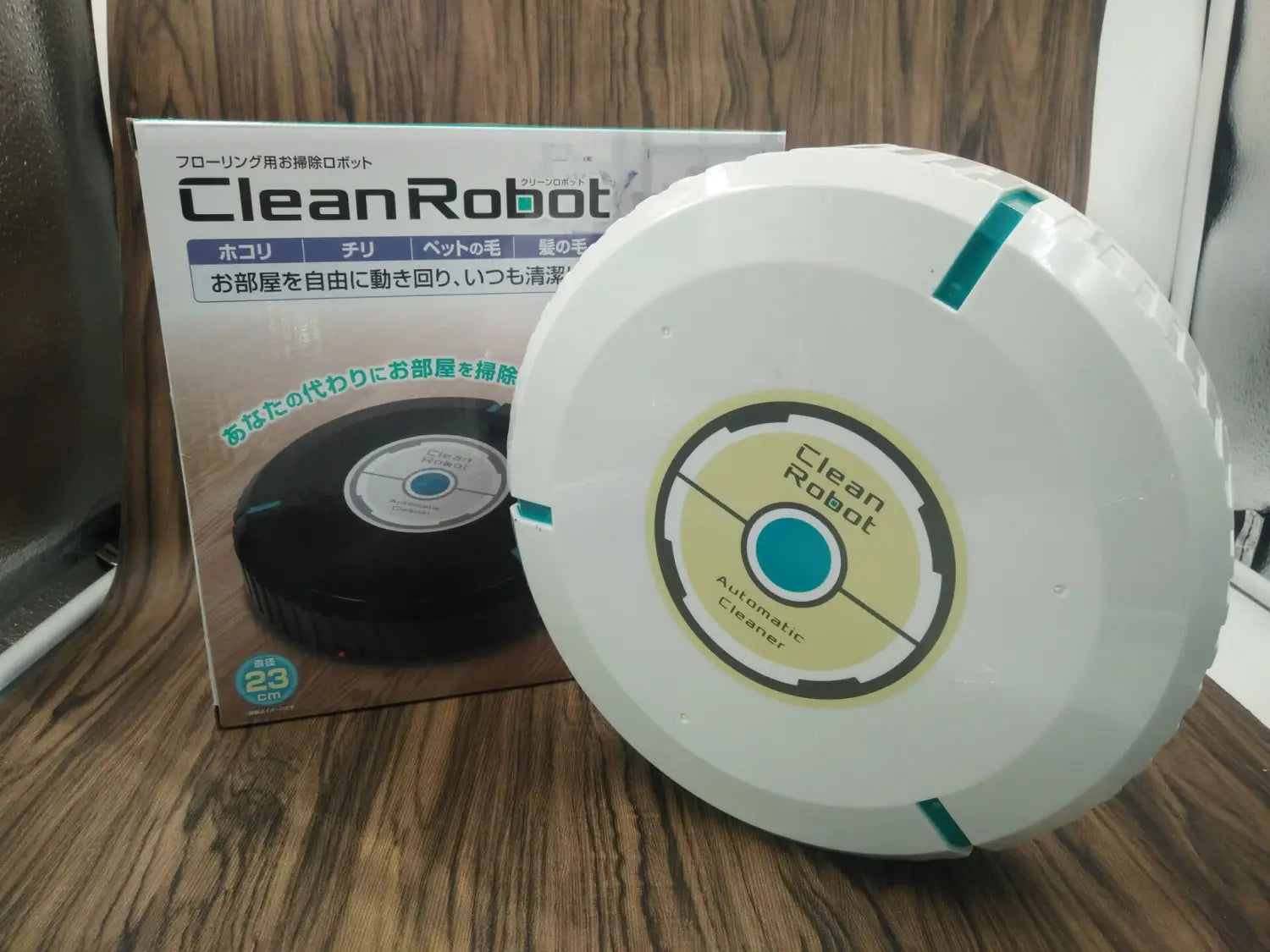 White circular robot household automatic sweeping machine with teal accents and a central clean robot logo designed for efficient household automatic sweeping.