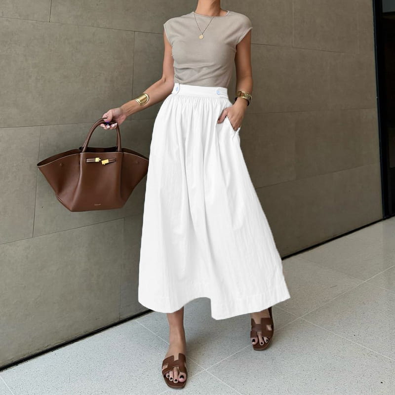 White cotton linen slimming large hem midi skirt with a high-waisted design, soft flowing fabric, and subtle pleats at the waistband.