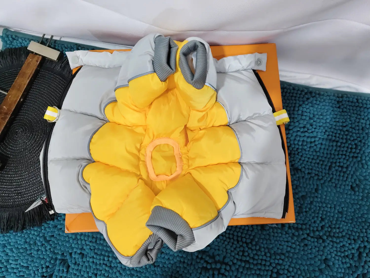 Yellow and gray quilted pet dog winter coat featuring a flower-like design on the front for dog winter clothes.