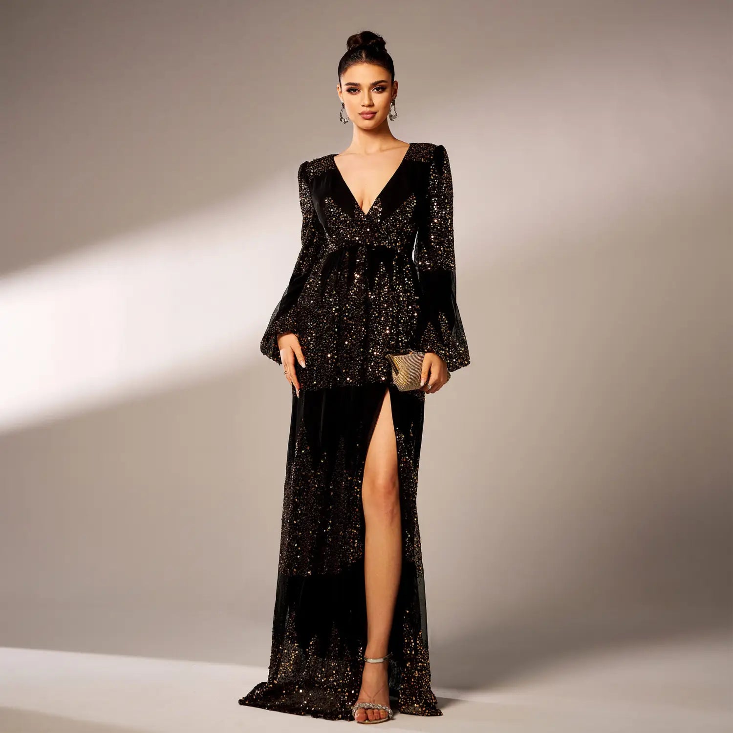 A glamorous black velvet rust bell sleeve sexy long sequined evening dress featuring a deep v-neckline and sparkling sequins.
