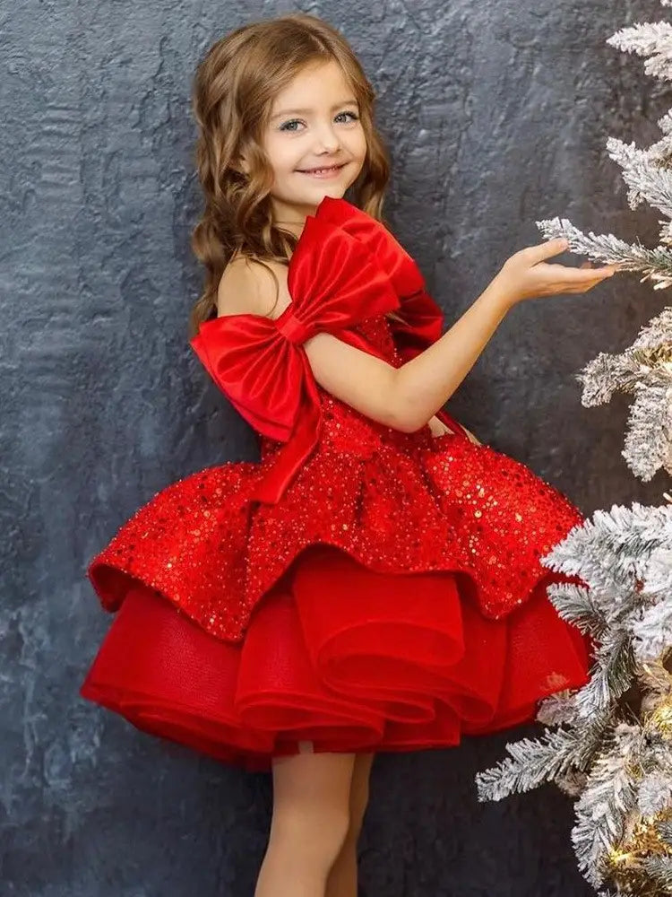 A vibrant princess dress red featuring a red tulle tutu skirt with sequins and oversized bow sleeves.