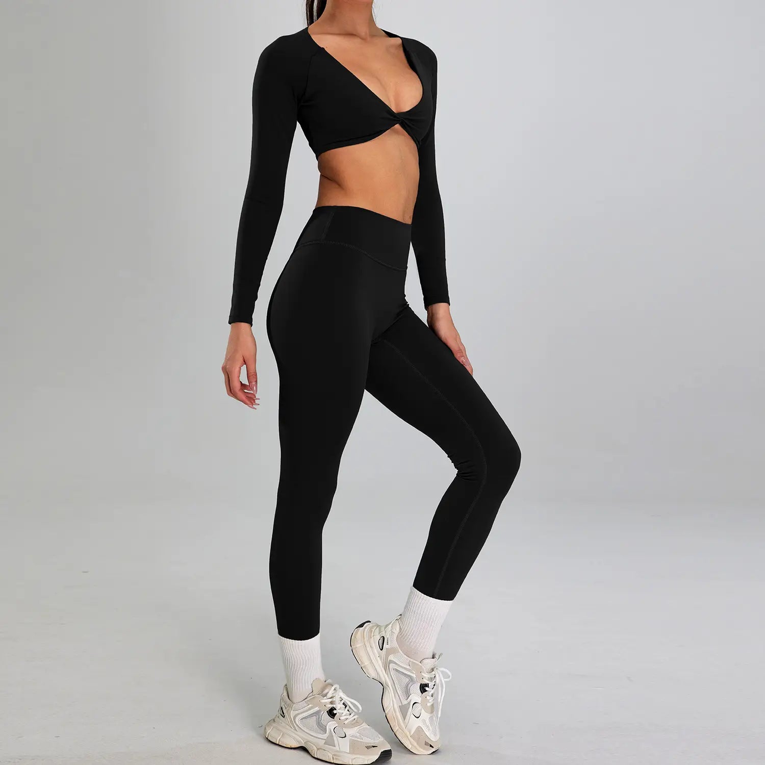 black long-sleeved crop top with deep v-neck and front twist detail paired with matching high-waisted leggings in a maroon high waist suit outdoor running nude set for sports suit outdoor use