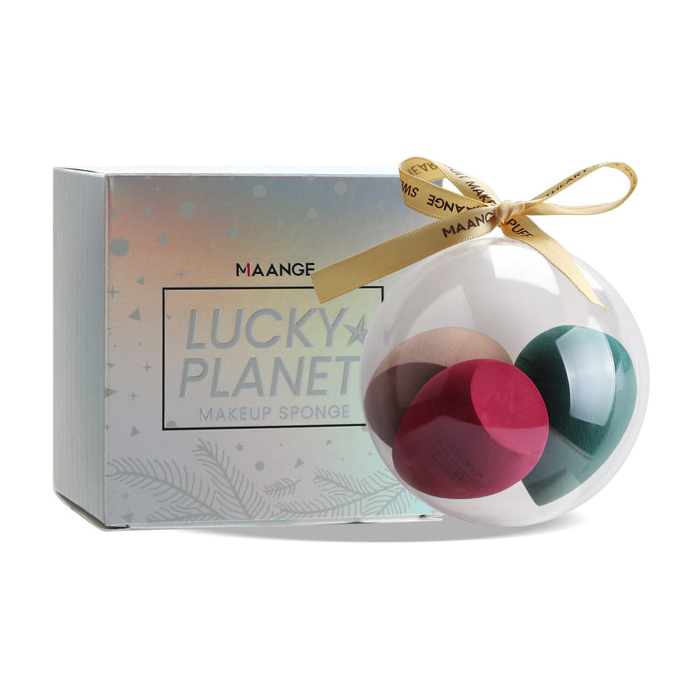 Clear spherical ornament containing three multicolored beauty egg makeup sponges in red green and beige for cosmetic application.