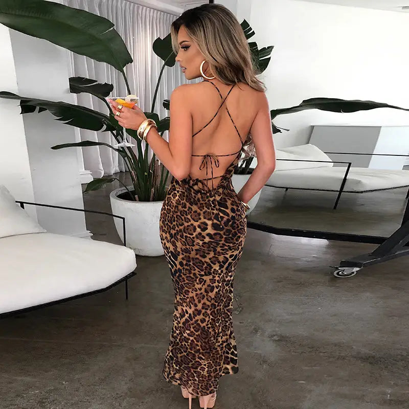 back view of a slim fit long leopard printed lace up maxi dress featuring a form-fitting silhouette and tie-back details