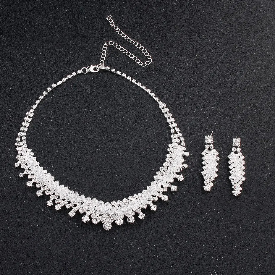 Silver rhinestone choker necklace with cascading crystal design and matching drop earrings as a wedding jewelry set for elegant bridal wear.