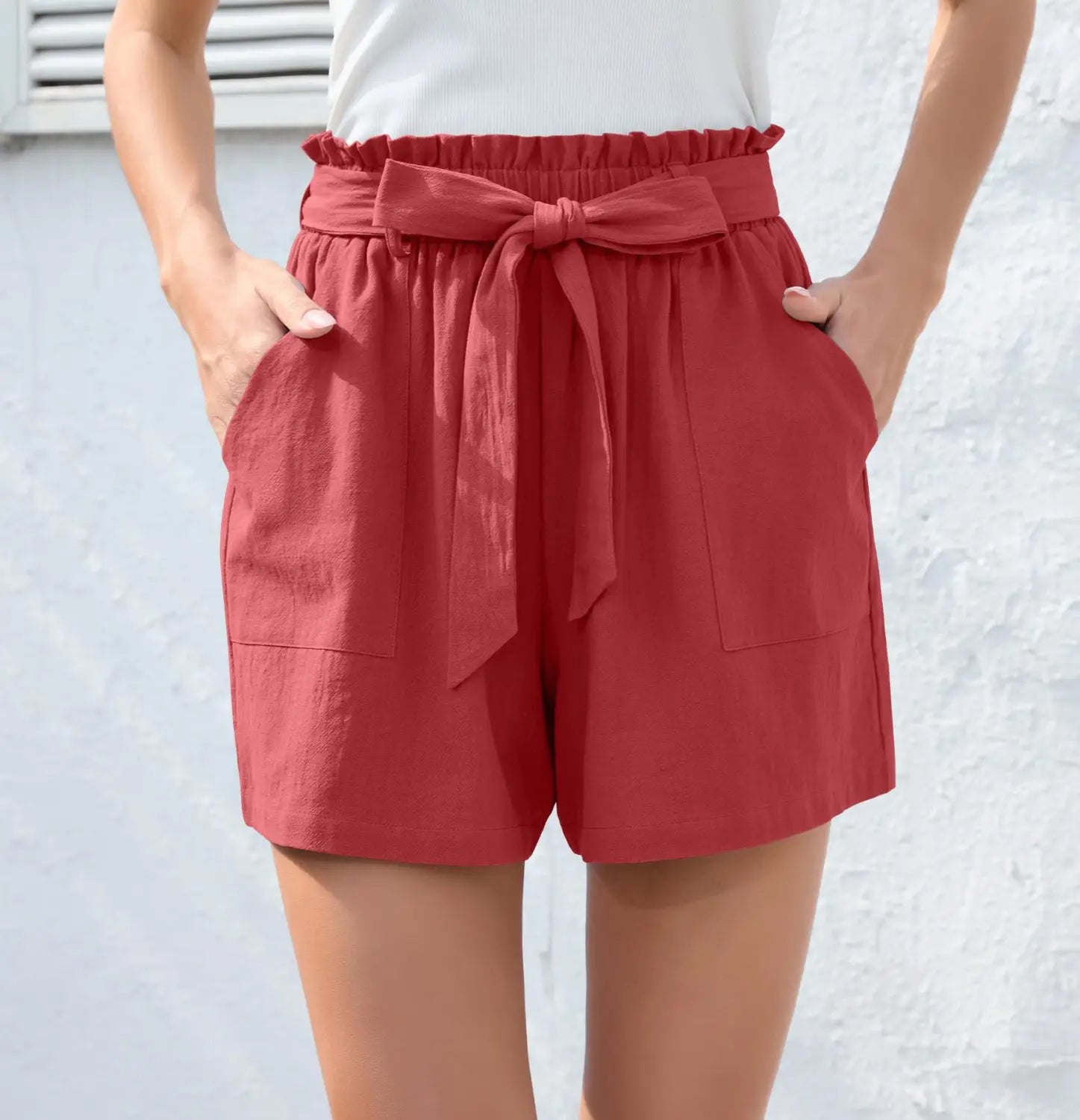 red high-waisted shorts with bow waist tie and two front pockets featuring fashion ruffle bow detail