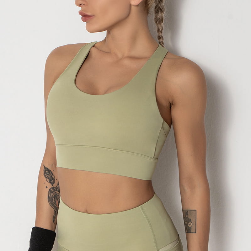 A sage green seamless women’s shockproof running sports bra with a supportive band and racerback design suitable for shockproof running yoga.