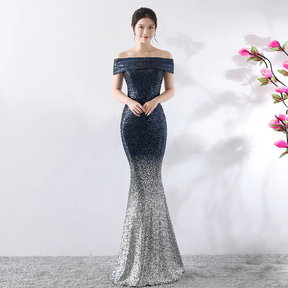 A shimmering navy-to-silver sequined off-the-shoulder mermaid gown designed as a party dress slimming birthday party dress and dress slimming host gown.