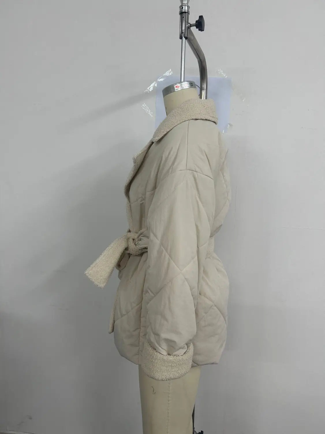 beige winter lapel plaid coat featuring a quilted design with a matching belt and fleece-lined collar for enhanced warmth and plaid coat fashion.