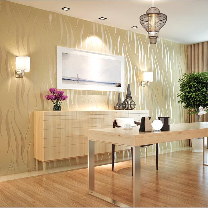 Light beige water ripple non woven wallpaper with wavy texture installed on a wall featuring recessed ceiling lights and framed artwork above a wooden cabinet, suitable for luxury women’s fashion boutique interiors.