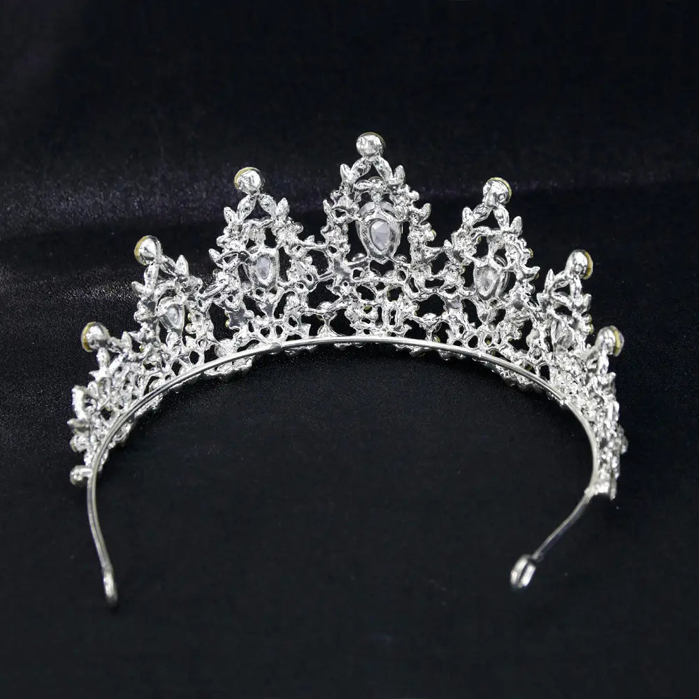 Silver European bridal crown with intricate lace-like metalwork and sparkling clear teardrop crystals designed as an elegant bridal crown