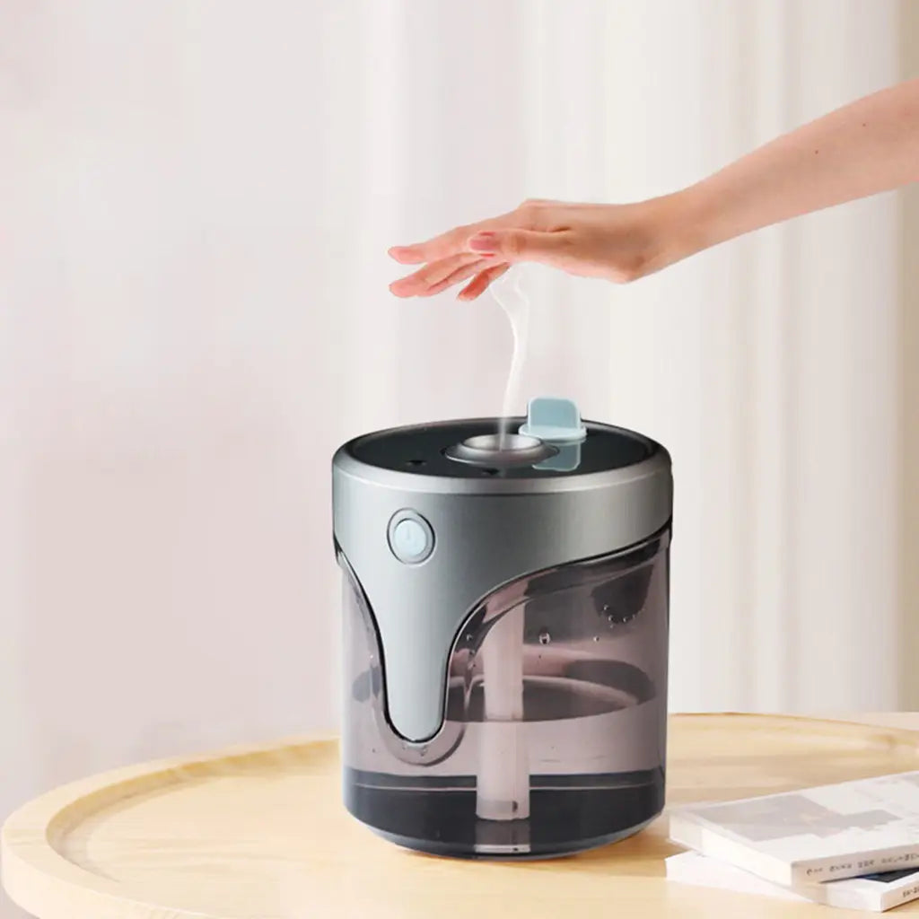 modern auto alcohol dispenser handsanitzer featuring a sleek cylindrical design with silver and black finish and a transparent water tank as an auto alcohol dispenser handsanitzer.