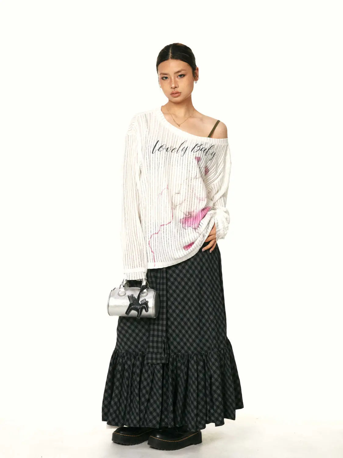 Silver metallic mini handbag with black horse silhouette design complementing a retro easy matching ruffled plaid fishtail skirt.