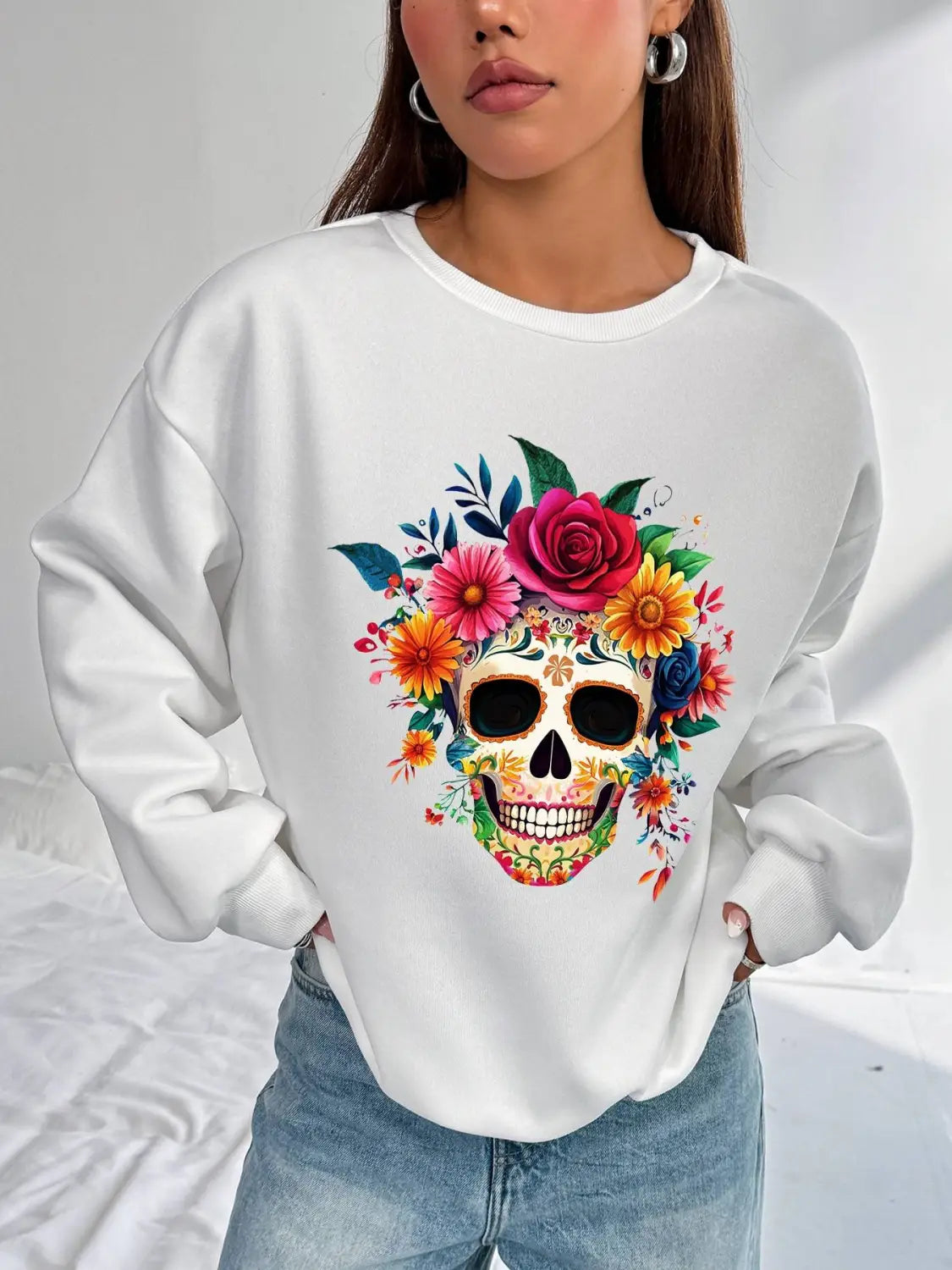 white basic long sleeve crew neck sweatshirt featuring a vibrant colorful floral skull design ideal for daily wear