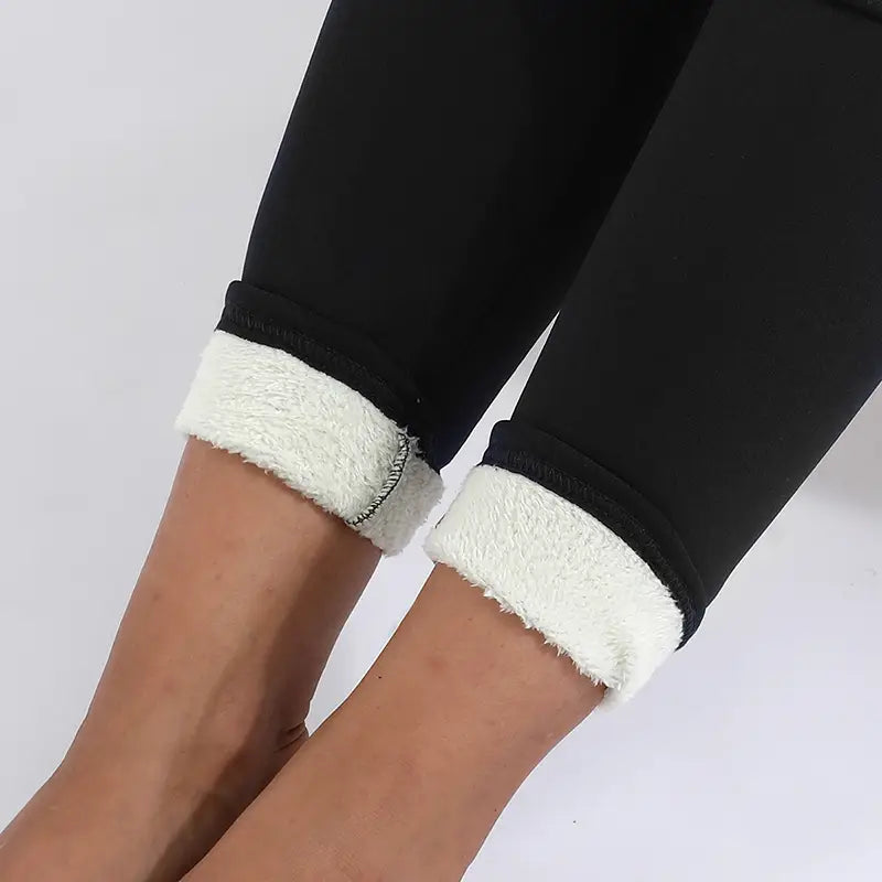 Black royal essence lux high stretch winter leggings featuring plush white fleece lining at the cuffs for added warmth and comfort.