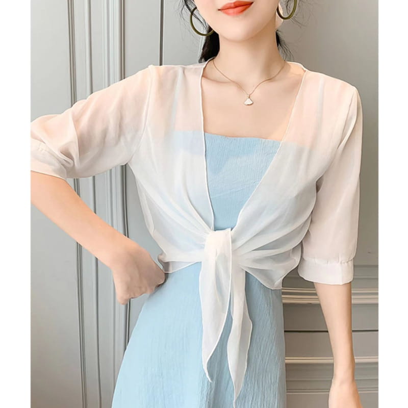 a sheer pale pink chiffon short shawl summer coat with three-quarter sleeves and a tied front knot designed as a summer coat sun cover.