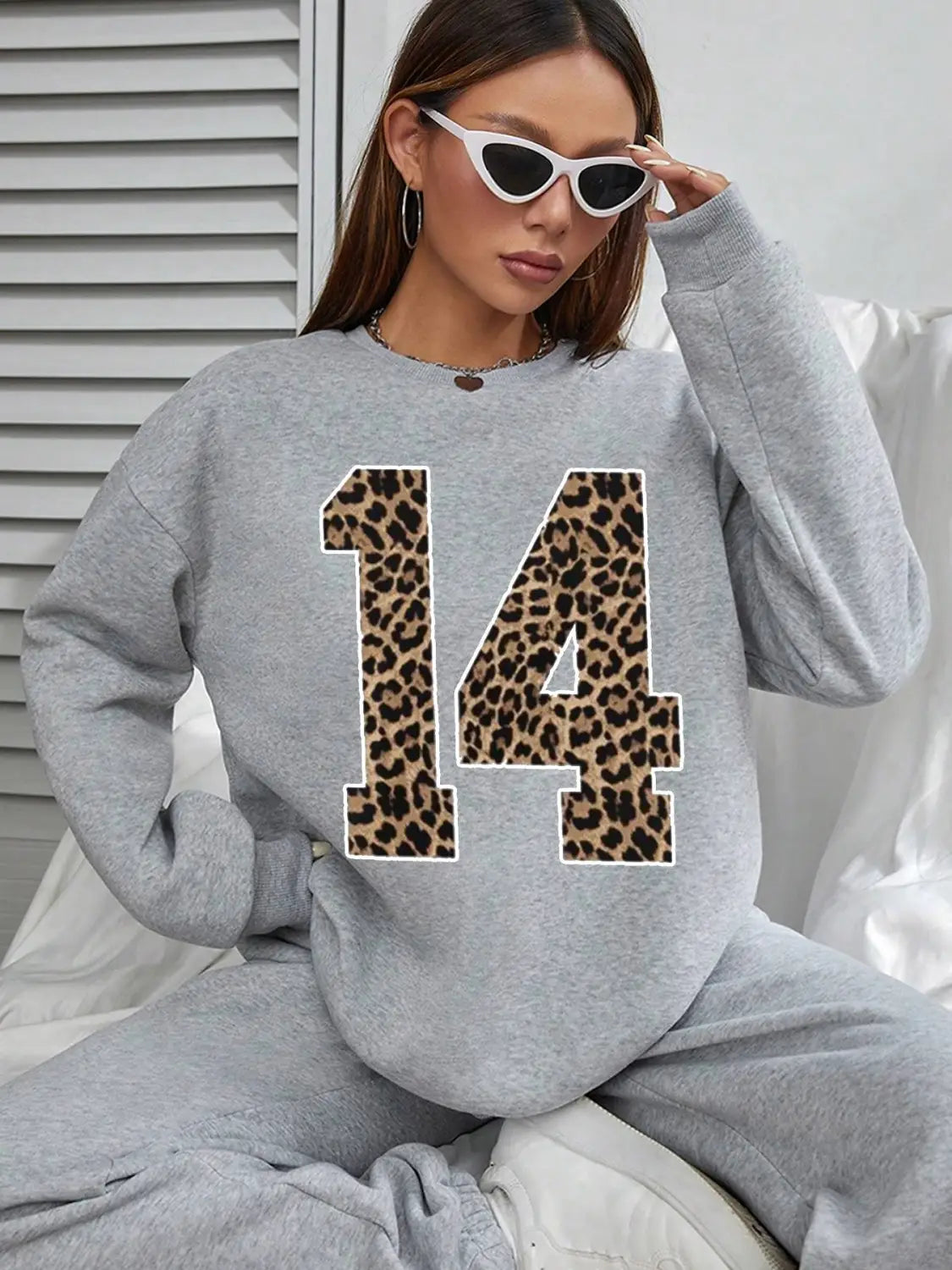gray crew neck sweatshirt featuring a bold black leopard-print number 14 on the front.