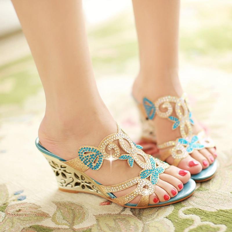 Gold embellished wedge sandals peep toe featuring turquoise accents and intricate floral designs on the upper material.