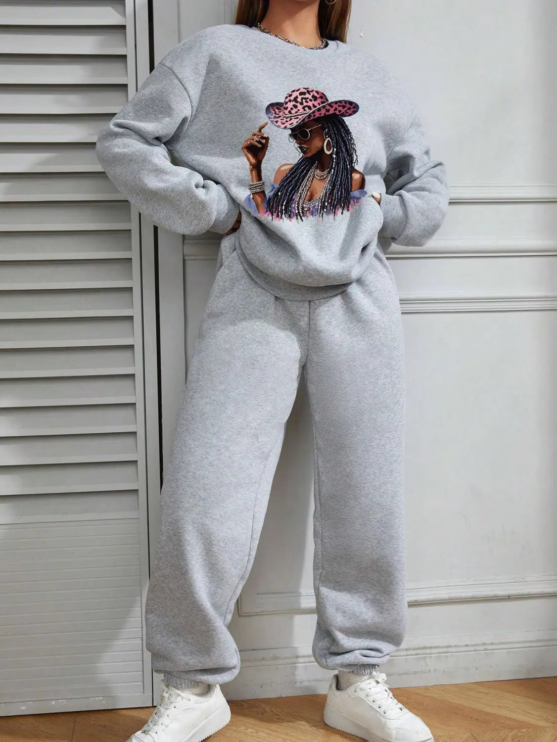 Gray long sleeve sweatshirt featuring a graphic print of a woman wearing a leopard-print hat and sunglasses.