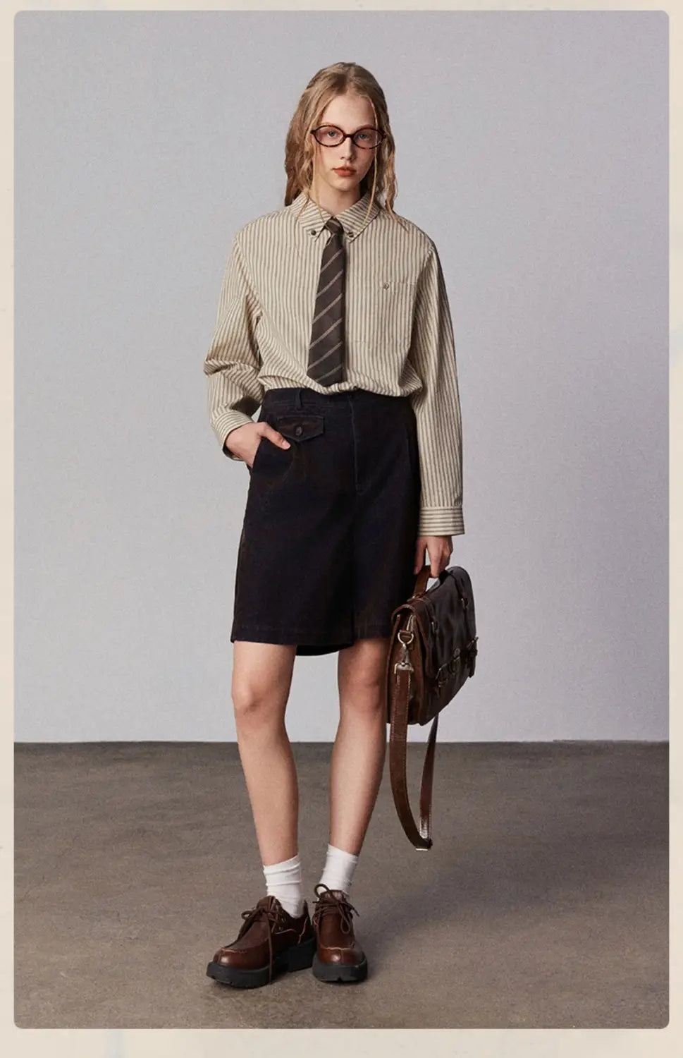 brown leather satchel with structured rectangular shape and visible stitching details complementing american retro casual striped cotton shirt for retro casual fashion.