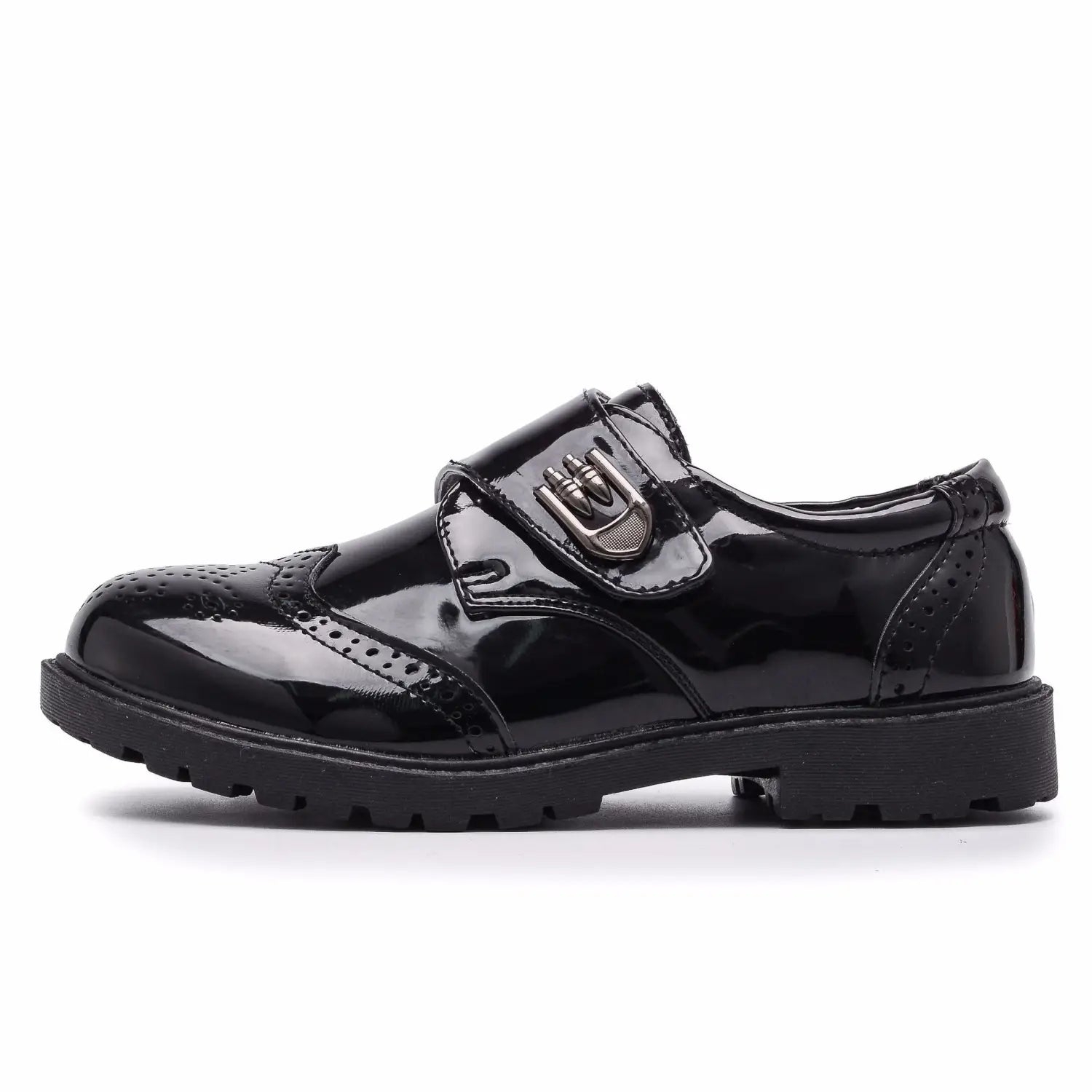 Boys black patent leather shoes with brogue detail featuring a silver buckle and textured rubber sole ideal for british casual single wear.