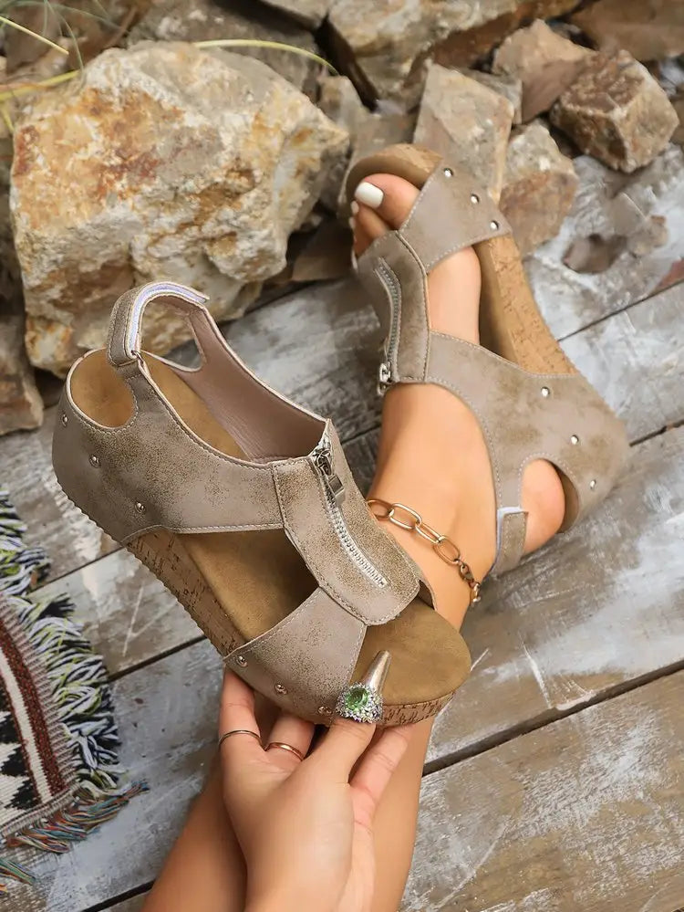 Beige suede lightweight height increasing wedge sandals with cork soles silver studs and black zipper detail ideal as summer zipper wedges and zipper wedges sandals.