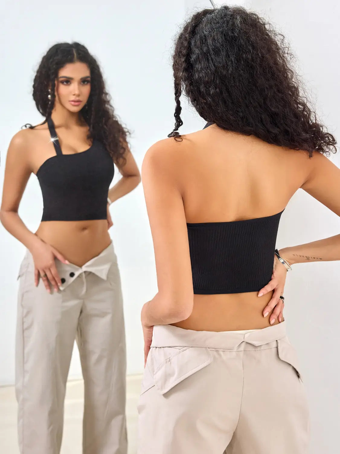 black ribbed solid color low cut one shoulder vest featuring a sleek form-fitting design in a solid color low cut sleeveless style.