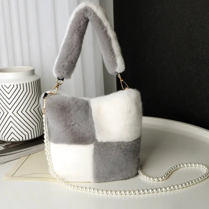 yellow checkerboard plush bucket bag featuring a cozy gray and white faux fur patchwork design with a pearl chain design strap.