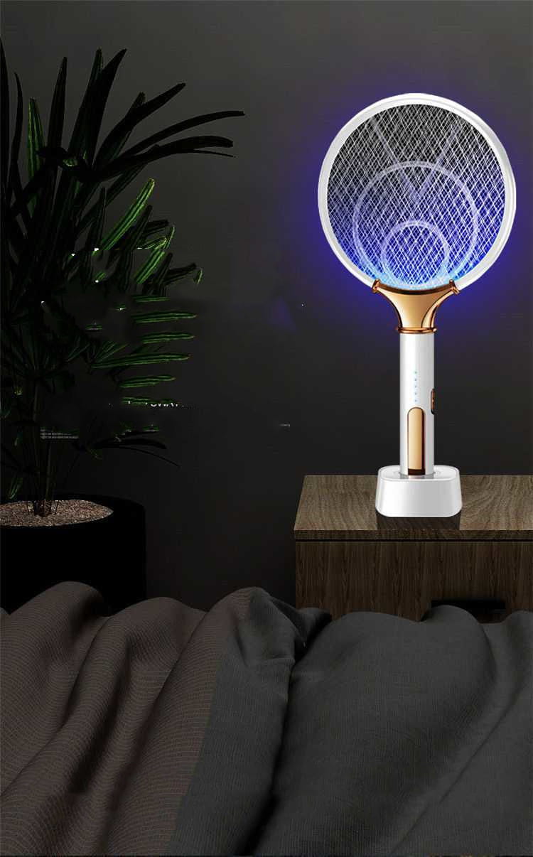 White and gold home bedroom electric mosquito swatter with a glowing blue mesh head for effective insect control.