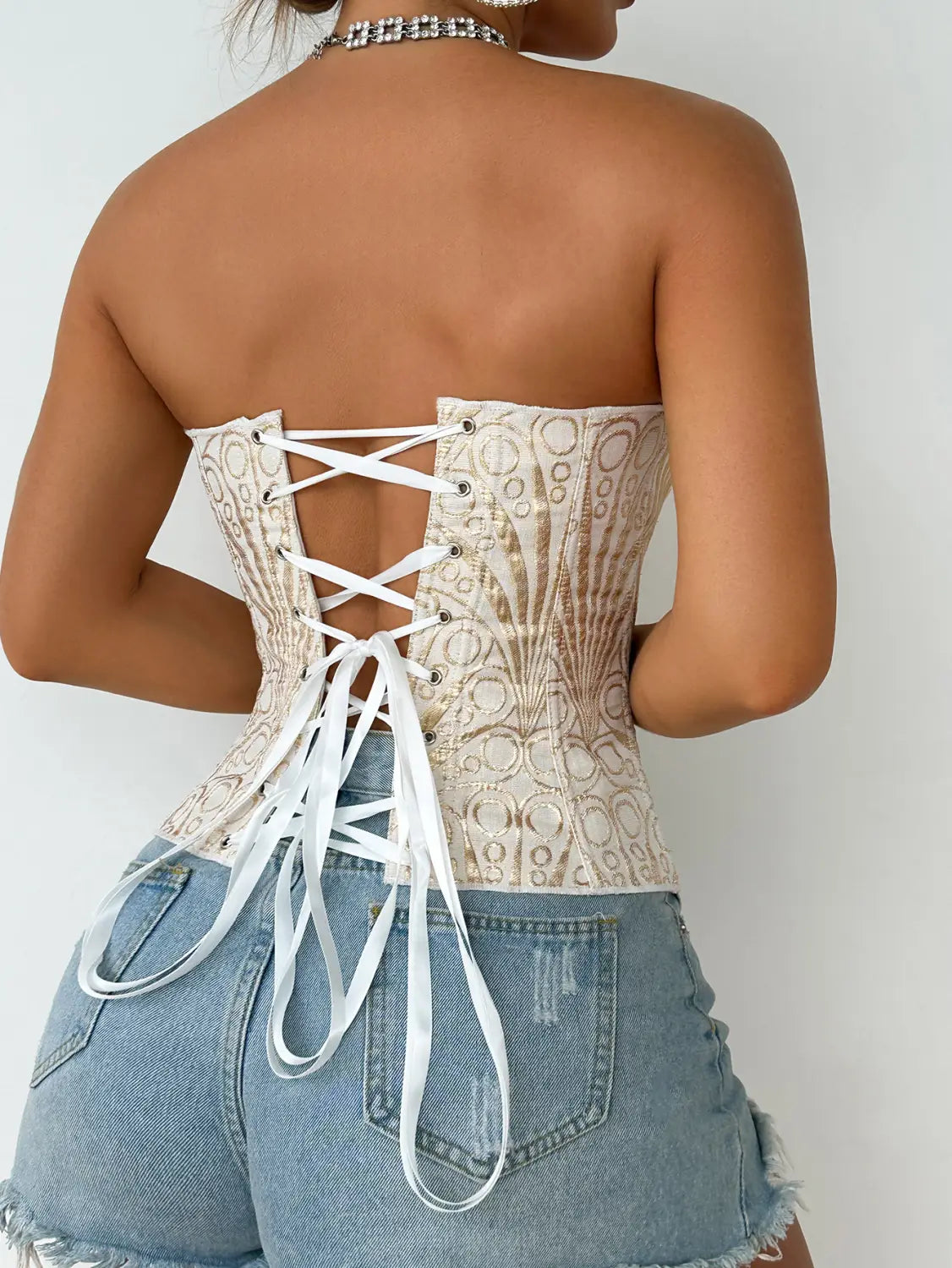 Beige lace party club corset with white satin lacing and circular pattern designed for streetwear party club and club corset clothing.