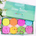 A set of eight colorful floral aromatherapy shower tablets in vibrant hues with dried flower petals and plant extracts