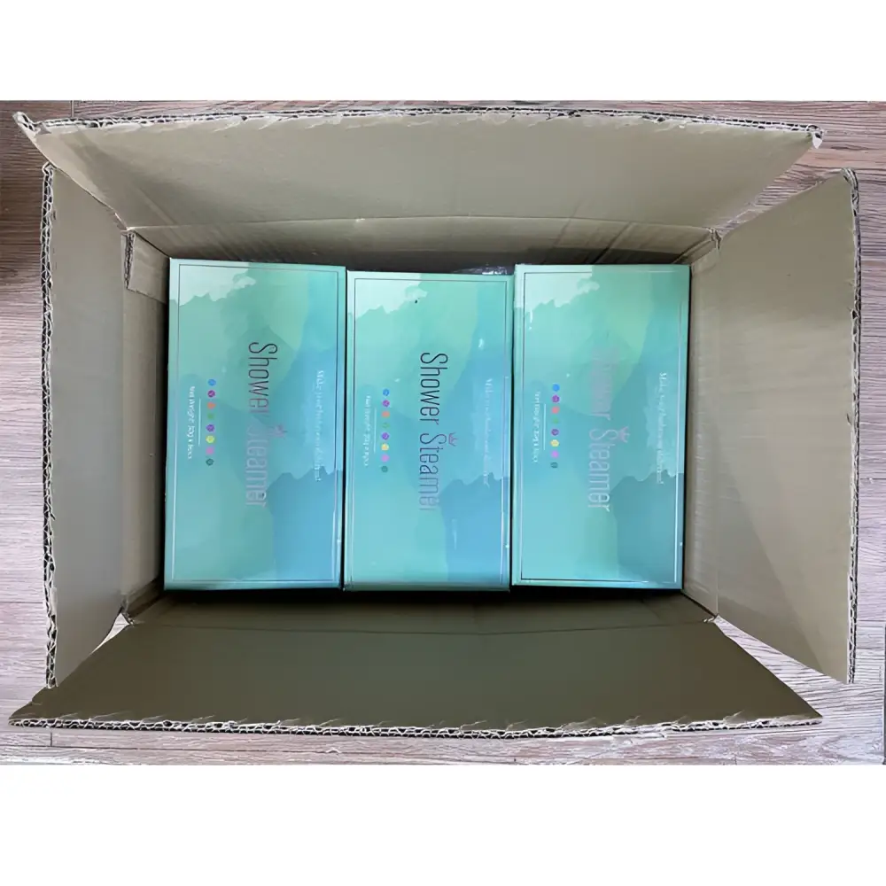 Three teal floral aromatherapy shower tablets in gradient boxes featuring plant extracts for relaxing use
