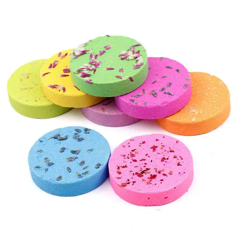 A set of 8 colorful floral aromatherapy shower tablets with plant extracts and dried flower petals in pink blue yellow green and orange